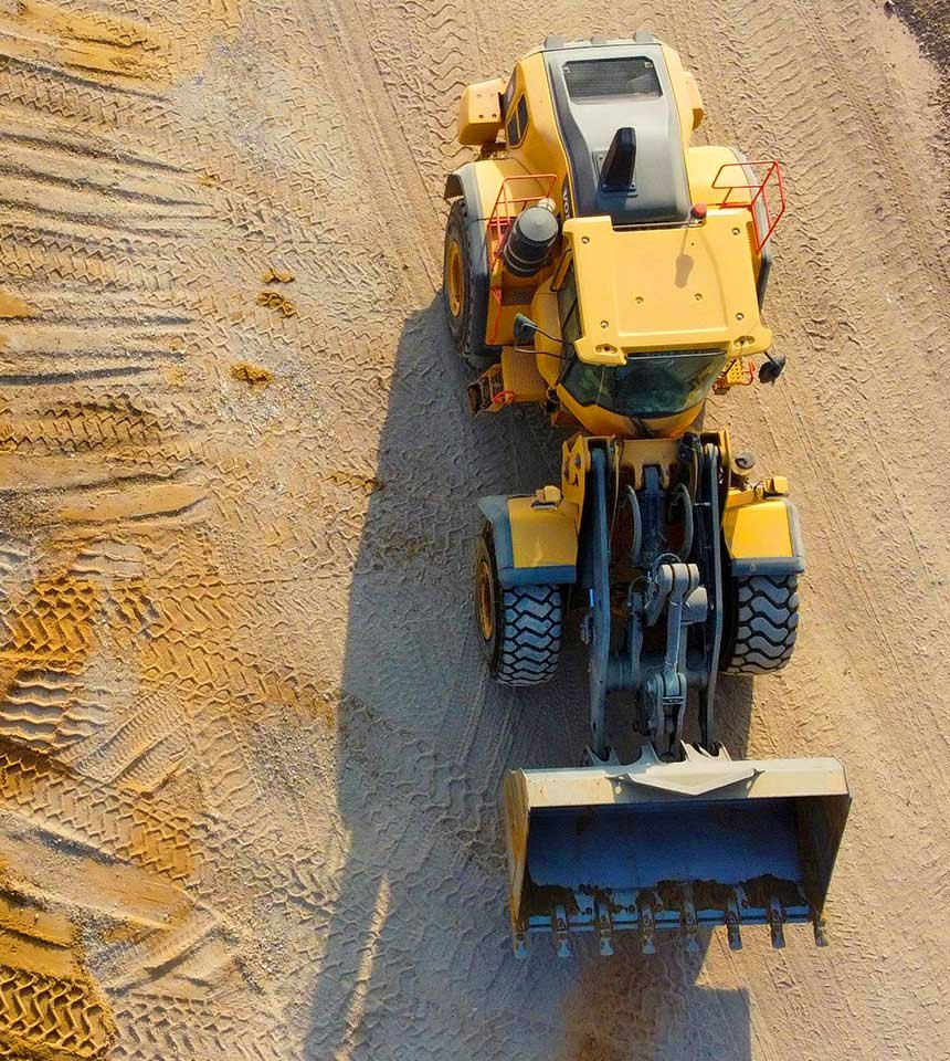 excavator installing conduit in trench Houston utilities